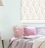 Pastel pink bedroom with floral artwork and comfy bedding.