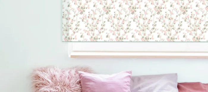 Pastel pink bedroom decor with floral wall art.