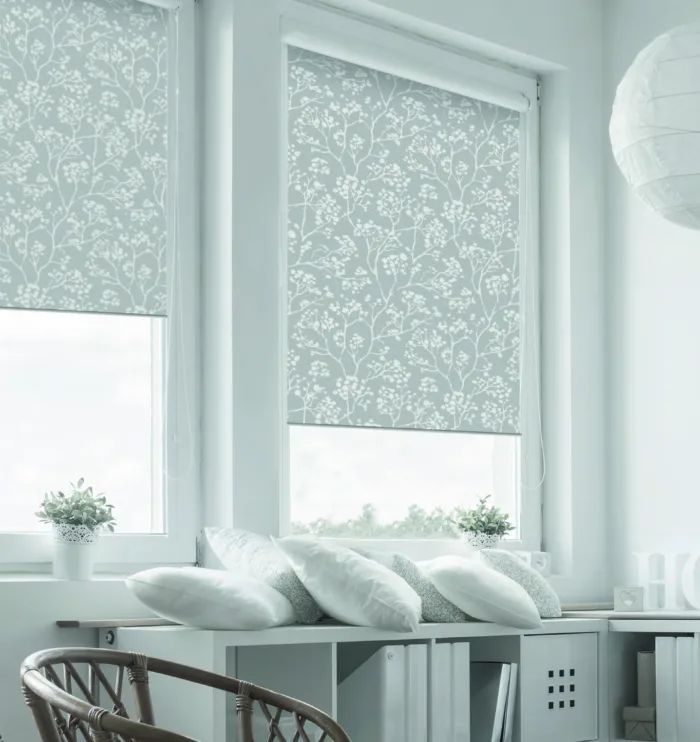 Serene home office with floral window blinds.