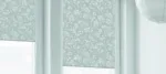 Elegant floral patterned roller blinds in soft blue hues.