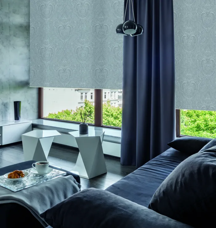 Modern bedroom with geometric furniture and city view.