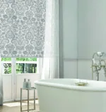 Elegant bathroom with clawfoot tub and floral wallpaper.