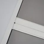Close-up of white window frame and grey screen mesh.