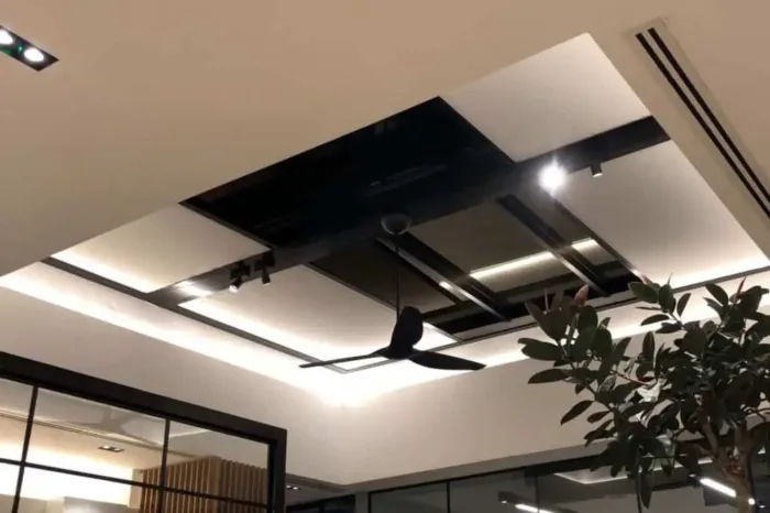 Modern ceiling design with bird decoration and lighting.