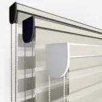 Close-up of horizontal window blinds with control chains.