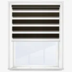 Modern striped zebra roller blind in window frame.