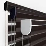 Close-up of modern striped roller blinds with control chains.