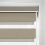 Brown striped roller blind on white window frame.