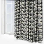 Geometric patterned curtains in front of a window.