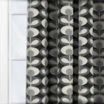 Modern black-and-grey patterned curtain in sunlight.