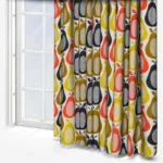 Colourful retro patterned curtains by a white-framed window.