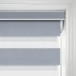Grey roller blind with white trim in modern interior.