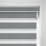 Grey striped blinds on white window frame.