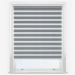 Grey zebra blinds in white window frame.