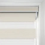 Beige roller blind on white window frame