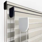 Close-up of modern window blinds with control mechanisms.