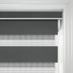 Close-up of grey roller blind in white frame.