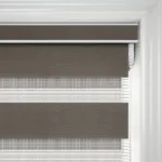 Close-up of brown roller blind and white venetian blind
