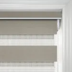 Close-up of grey window blinds with white frame