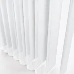 Close-up of white vertical fabric blinds in soft light