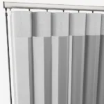 Grey vertical blinds on window track system