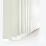 White vertical blinds in soft light, close-up view.