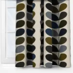 Patterned curtains in green, blue, and grey tones.