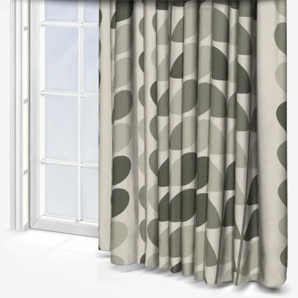Patterned grey curtains beside a sunlit window.