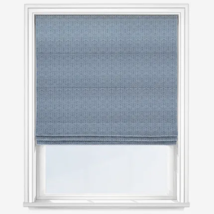 Blue herringbone patterned window blind on white frame.