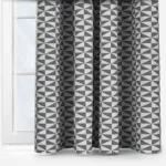 Geometric pattern curtains in grayscale by window.