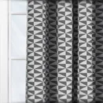 Geometric patterned curtains in grayscale, interior design detail.