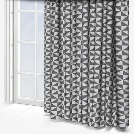Geometric patterned curtains beside a white-framed window.