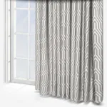 Geometric patterned curtains beside a bright window.