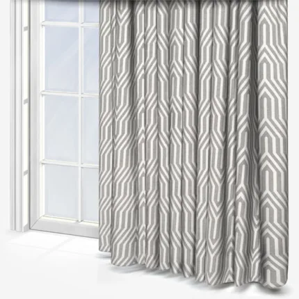 Geometric patterned curtains beside a bright window.