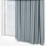 Grey curtains beside a white window frame
