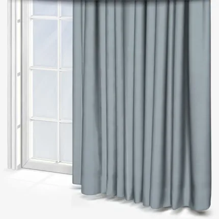Grey curtains beside a white window frame