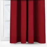 Red curtains hung in front of a white door.