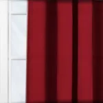 Red curtains before a white window frame.
