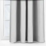 Grey curtains in front of a bright window.