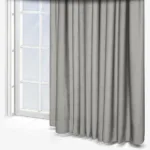 Grey curtains drawn across a bright window.