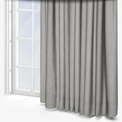 Grey curtains draped over window in bright room.