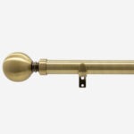 Brass curtain rod with finial and bracket.