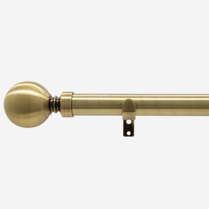 Brass curtain rod with finial and bracket.
