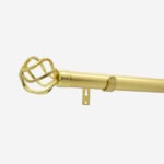 Gold curtain rod with decorative finial on white background.