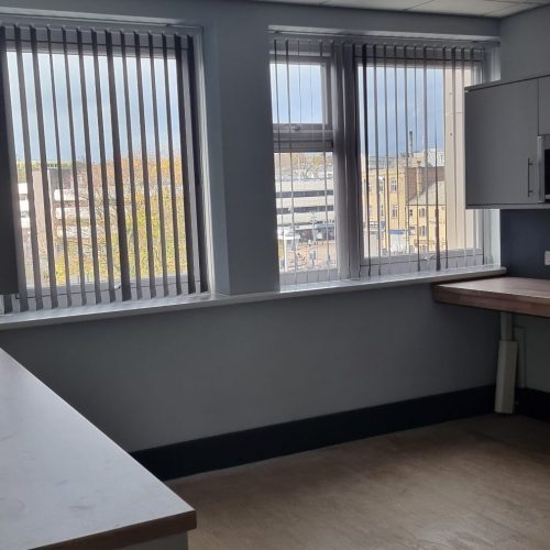 Empty office interior with large windows overlooking city