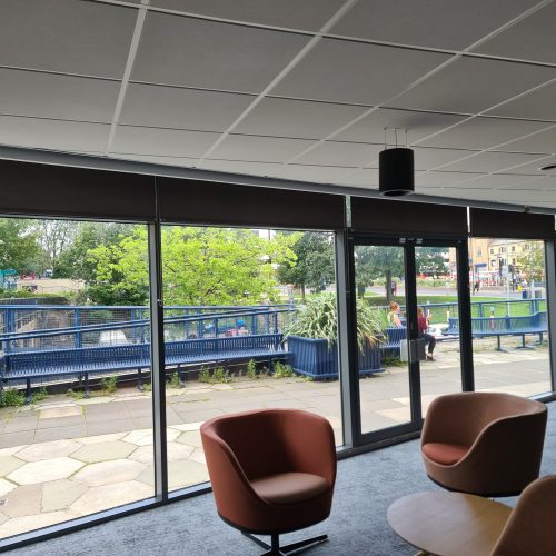 Modern office lounge overlooking urban park.