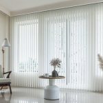 Modern living room with vertical blinds and stylish decor