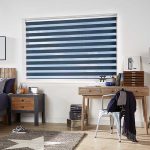 Stylish bedroom with striped blinds and wooden furniture.